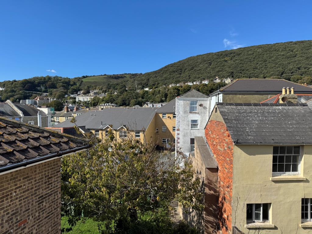 Lot: 141 - FOUR-BEDROOM HOUSE FOR IMPROVEMENT WITH SEA VIEWS - The View from the Rear Over the Town